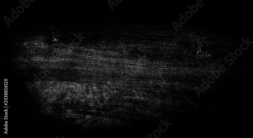 Fotografija Abstract dark background with white scratch marks and dust particles adding textured and grunge effect, providing a gritty and distressed surface overlay