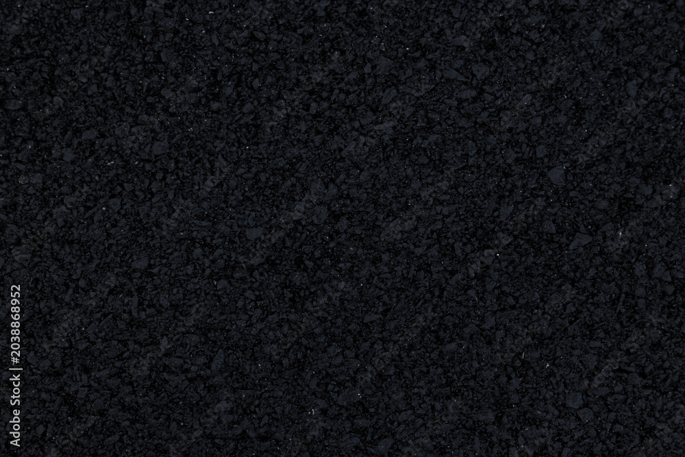 Fototapeta premium The background image shows a freshly laid asphalt surface, just a few hours old, with a clear, almost completely black texture.