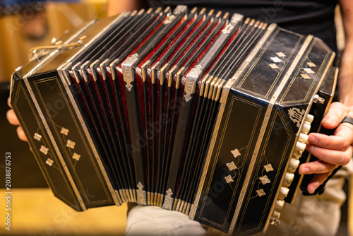 Bild auf Leinwand Close up of vintage black bandoneon accordion bellows with red fabric