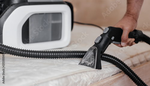 Fotografie Professional mattress cleaning with extraction vacuum cleaner nozzle and equipme