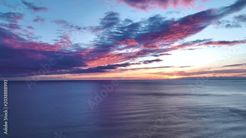 Aerial Video of Serene Evening Sky With Gentle Pastel Clouds and Golden Sunlight Touching Ocean Horizon