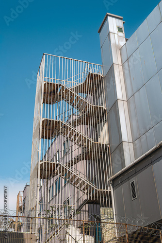 Metal fire and emergency exit stairs on the building facade.