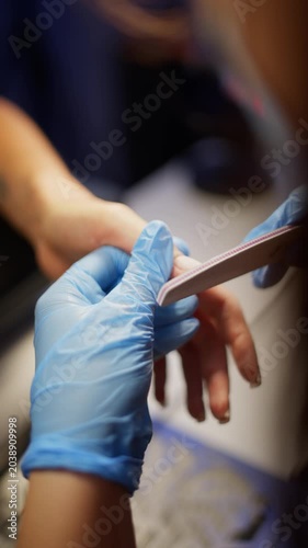 Professional manicurist shapes nails with nail file. Caring for female hands in beauty salon. High quality 4k footage