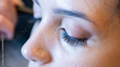 Vászonkép Eyelash styling and makeup touch-up for a bride on her wedding morning preparati