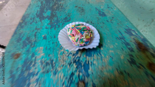 Close-up of brigadeiros on a green wooden table.