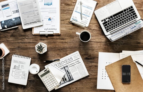 Business workspace, office desk, laptop, papers, coffee cup, productive environment
