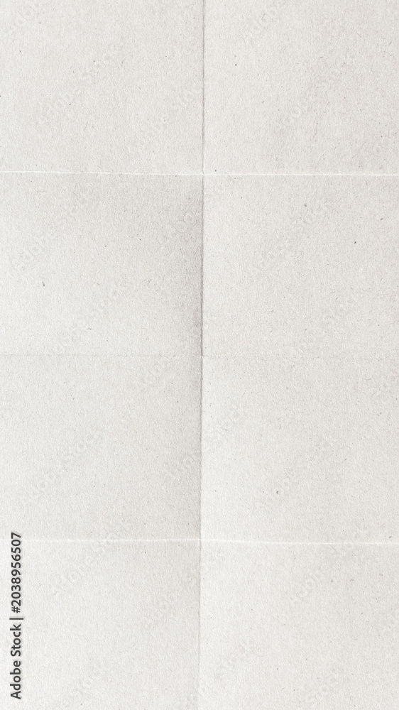 Fototapeta premium A textured, folded white paper background with subtle creases.