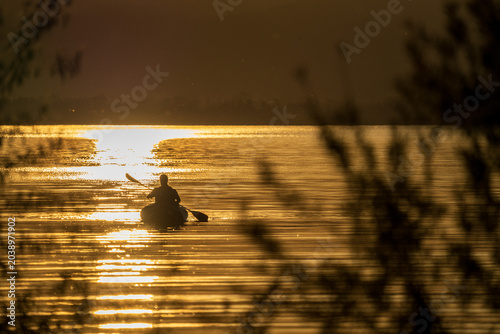 Obraz na plátně a lone kayaker paddling on the calm surface of Lake Czorsztyn at sunset