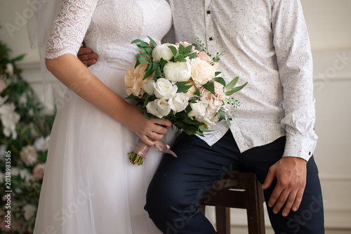 Photos bride and groom together holding wedding bouquet