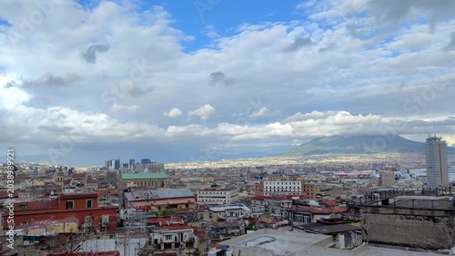  Wide city skyline view of Naples under cloudy sky