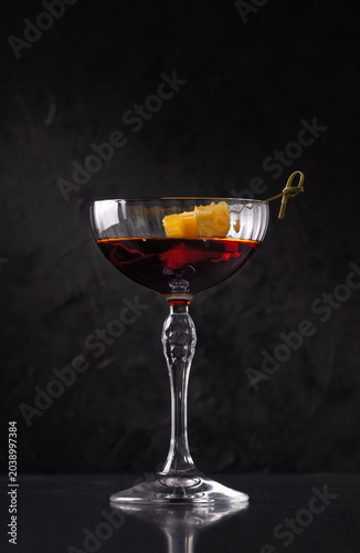 Martini - Rosso, cocktail drink with orange on minimalistic background. On a dark stone background