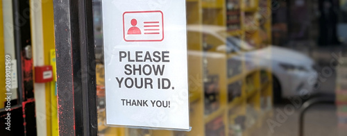 Tableau sur toile Please show your ID sign on a glass door, identity verification notice at shop e