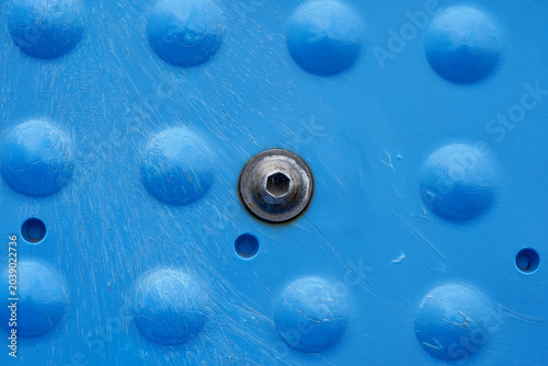 Close-Up Blue Textured Surface with Metal Screw Detail