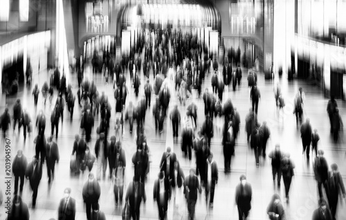 Tokyo, Japan: intentionally blurred image with large number of people passing  train station to show the large masses