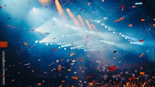 Confetti falling at a vibrant concert with stage lights, celebration, party atmosphere