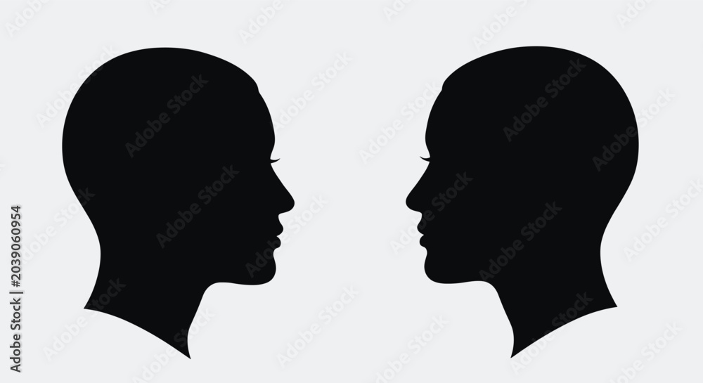 Fototapeta premium Two identical black silhouettes of human heads facing each other representing communication or psychology concepts.