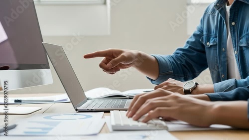 Business team collaborating on a project using computers