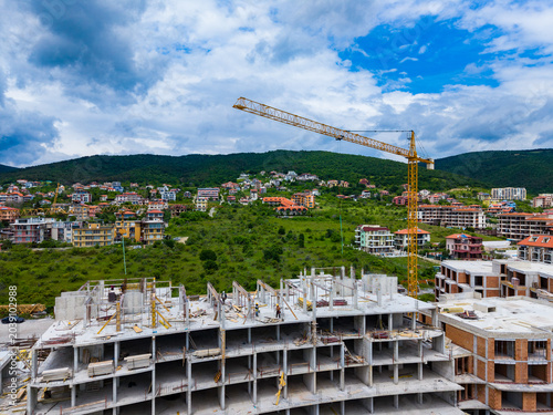 Photos Construction work is underway on a building in a developing area under a cloudy
