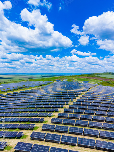 Vast solar array supporting climate action goals, continuous rows stretching to horizon, reflective highlights, potential for megawatt generation, strategic renewable investment