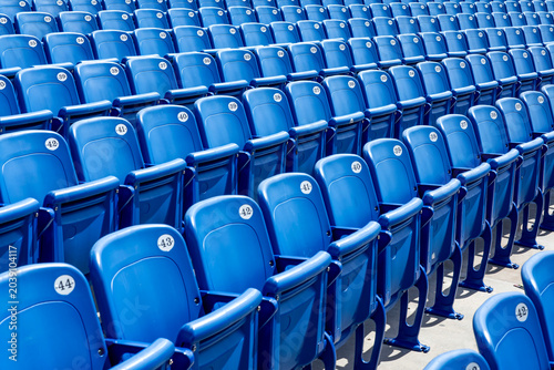 Rows of blue stadium seats
