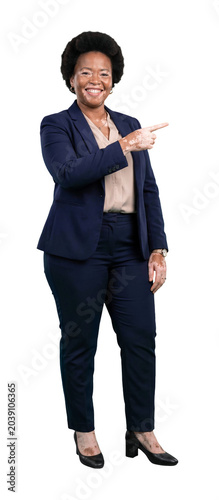 Confident black businesswoman with vitiligo smiling and pointing aside with her finger isolated on transparent background