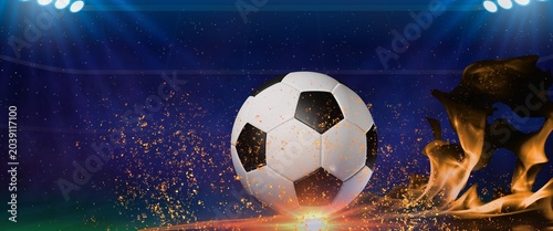 Принти на полотні Soccer ball on a lit stadium pitch, surrounded by glowing fire and golden sparks