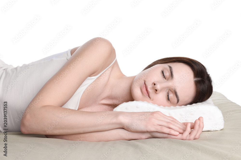 Obraz premium Woman sleeping on bed with orthopedic pillow against white background