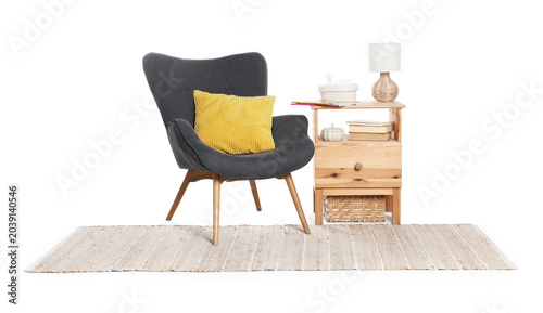 Tableau sur toile Grey armchair with cushion, wooden dresser, decor and lamp isolated on white