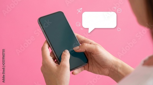 Hands Holding Smartphone with Chat Bubble Pink Background