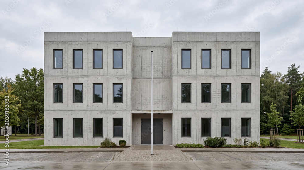 Fototapeta premium Symmetrical Facade of a Minimalist Garrison Administration Building Raw Concrete Architecture Exterior Design Photo View