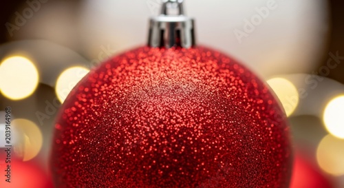 Shiny Red Christmas Ornament with Warm Bokeh Lights.
