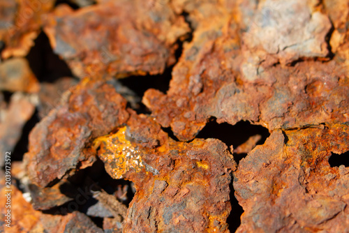 Rust corrosion metal texture iron oxide peeling surface closeup of weathered steel with flaky red patina and rough cracked detail, gritty industrial background for decay concept