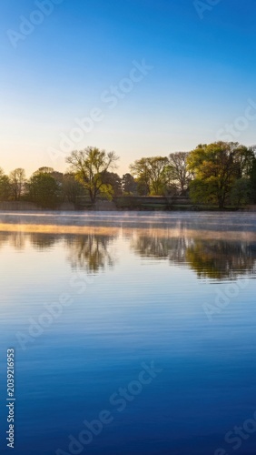 Serene Morning Mist Over Calm Lake