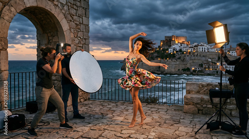 dramatic location photo shoot of elegant modern woman model in bright floral dress spinning in coastal European village on a stormy evening