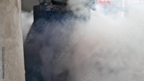 Dangerous high pressure steam leak from a rusty industrial pipe valve