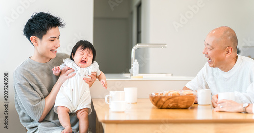 Photos A father comforting a crying, fussy baby; a father and grandfather