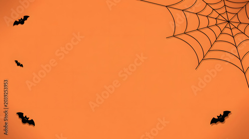 Spooky Halloween Background: A minimalist Halloween-themed background featuring a silhouetted spiderweb in the upper right corner and several small.