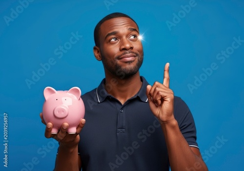 Man holding pink piggy bank.