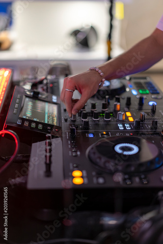 Obraz na płótnie DJ hand operating professional music mixer console