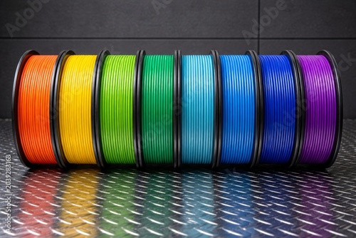 Colorful 3D printing filament rolls on industrial metal surface concept. Ai generative