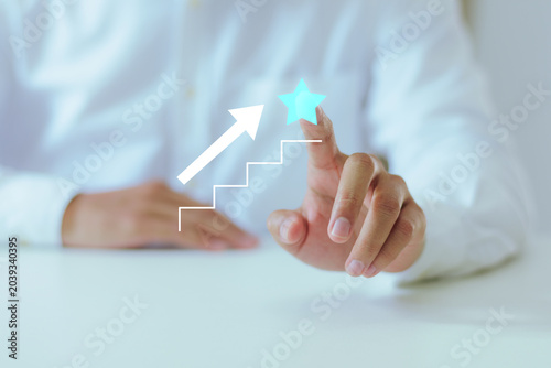 Close up of man reaching milestone illustrating business growth, career development, successful target achievement, financial ambition, and performance award concepts.