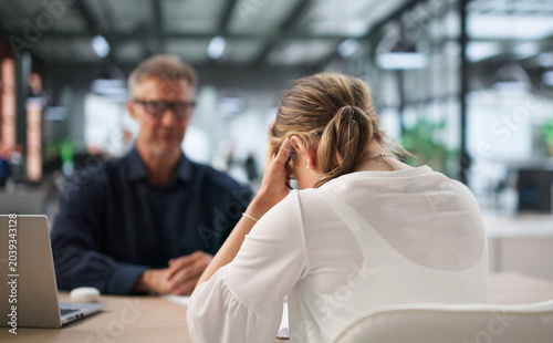 Obraz na płótnie Two Office Workers Discuss Hiring Mistake During Tense Disciplinary