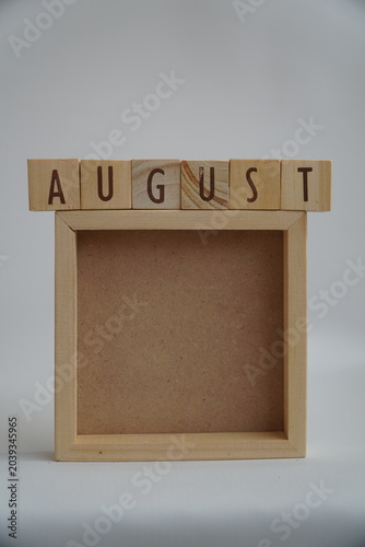 Minimalist Wooden Blocks Spelling August Above Empty Square Frame Template