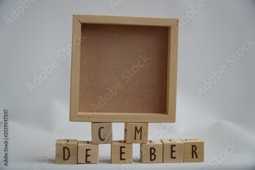 Wooden Frame with December Letter Blocks Displaying Festive Holiday Season Concept