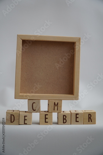 Rustic Wooden Square Frame Displaying the Word December Written with Scrabble Tiles