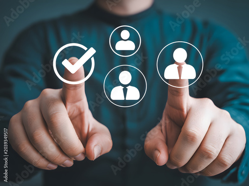 A person selecting a user icon from a group of three on a digital screen, symbolizing user selection or account management.