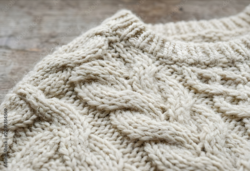 Fototapeta premium Close-up of cozy cream cable knit wool sweater