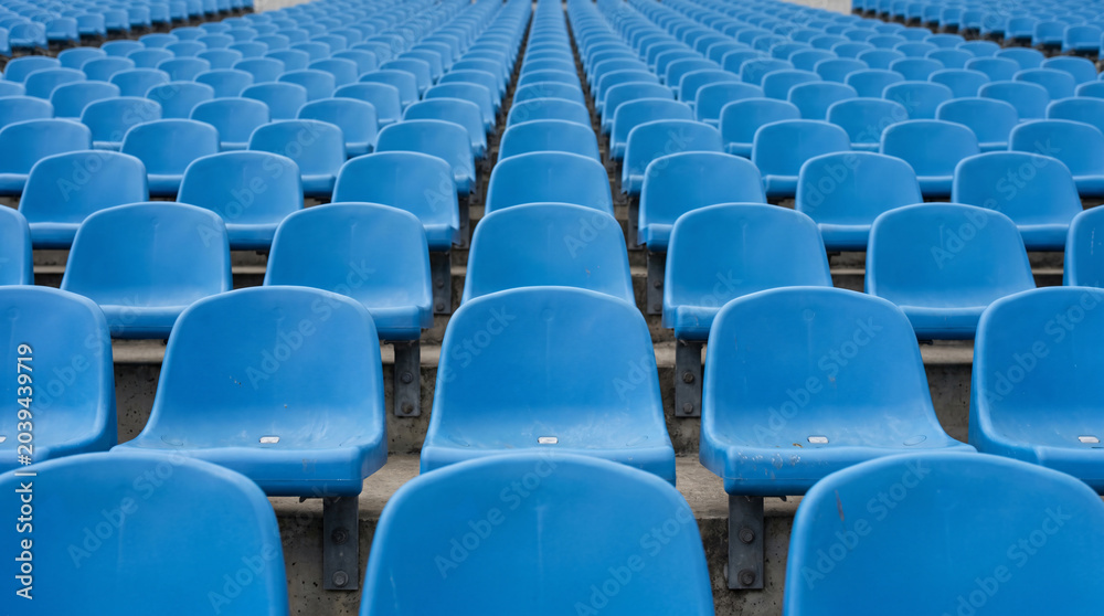 Naklejka premium Symmetrical Rows of Blue Empty Plastic Seating in an Outdoor Stadium