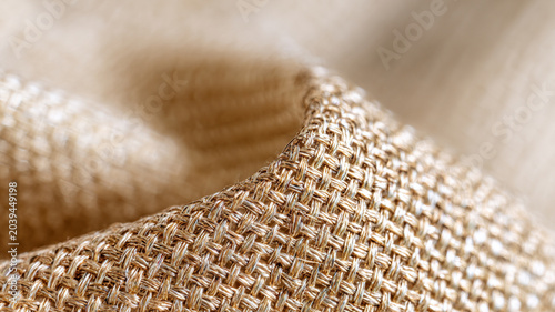 Macro close-up of metallic gold woven fabric texture