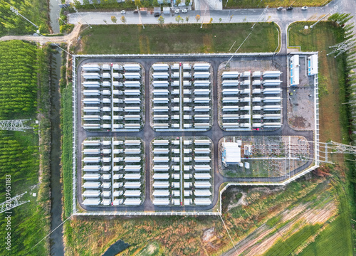 Sticker Aerial view of industrial energy storage battery container facility in a green p